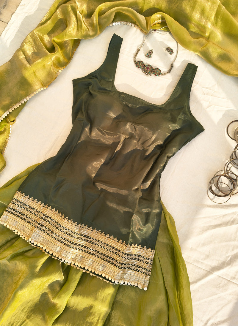 Green kurta, dupatta and lehenga with gold border on a white surface